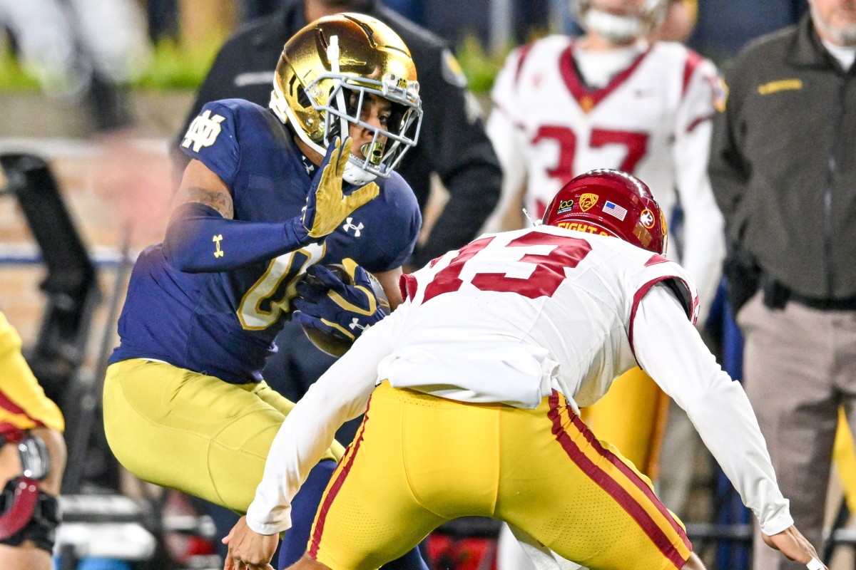 Williams (13) attempting to make a tackle off of his own interception. 